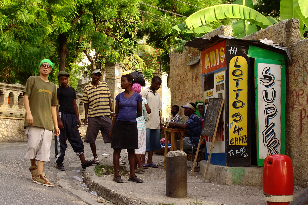 people standing in the street in front of some stores