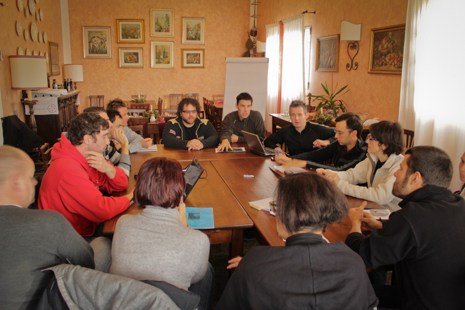 a group of people sitting around a wooden table