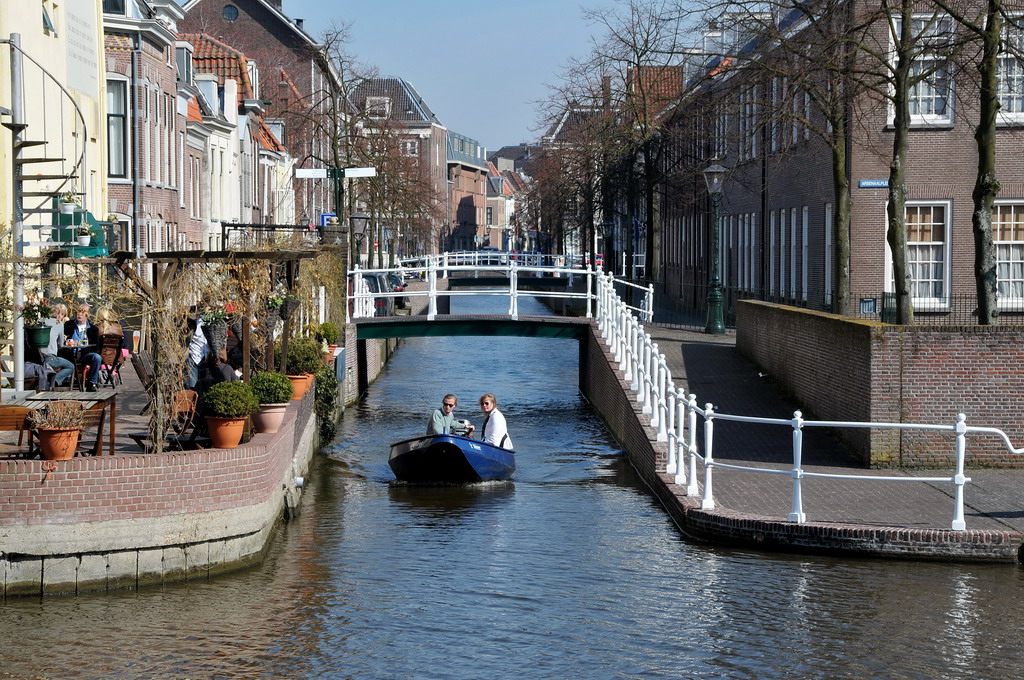 a blue boat is going through the canals of a city