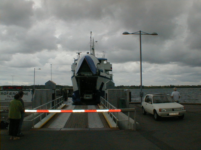 a small vehicle is loading a boat onto the pier