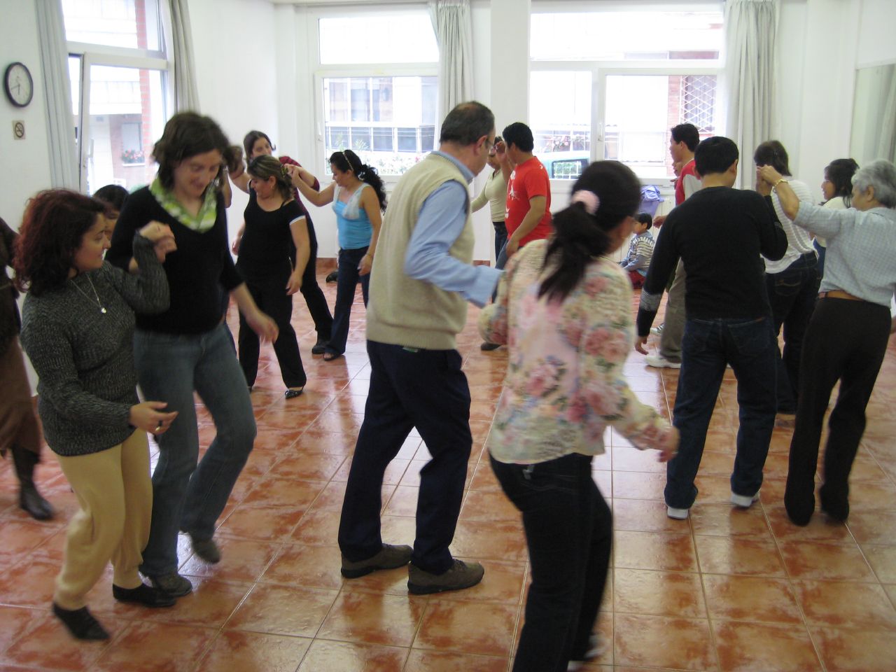 a group of people are dancing and having fun