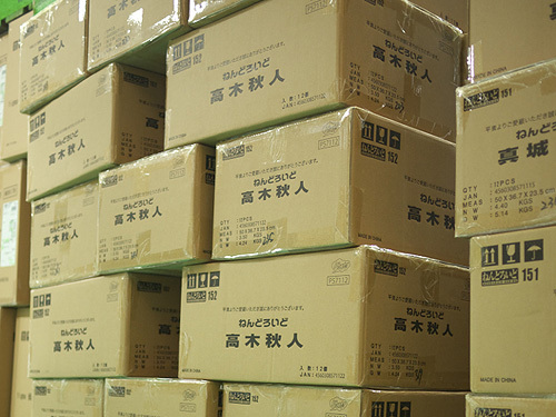 lots of boxes are stacked up in the warehouse