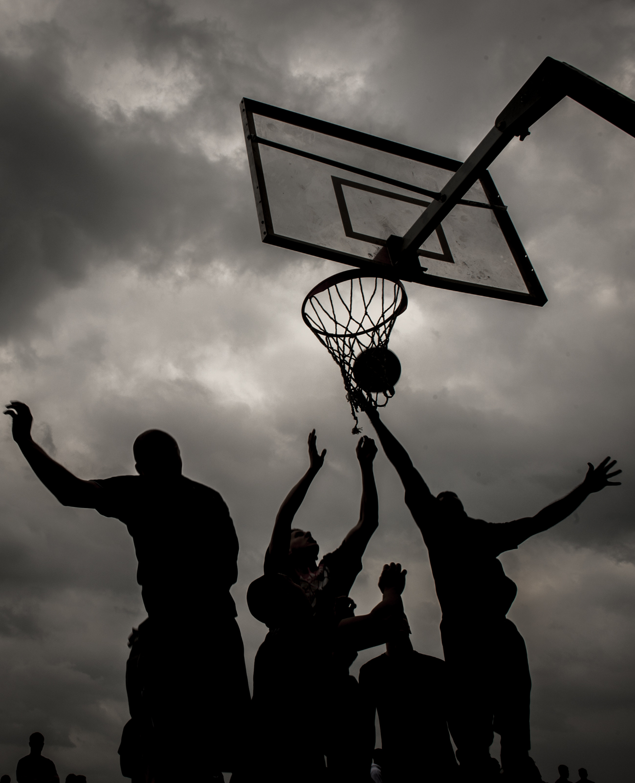 a black and white po of several people playing basketball