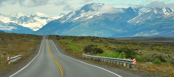 a highway stretching into the distance in a mountainous area