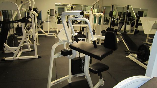several machines and other gym equipment in a room