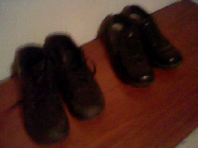 some black shoes and one brown floor and one is laying down