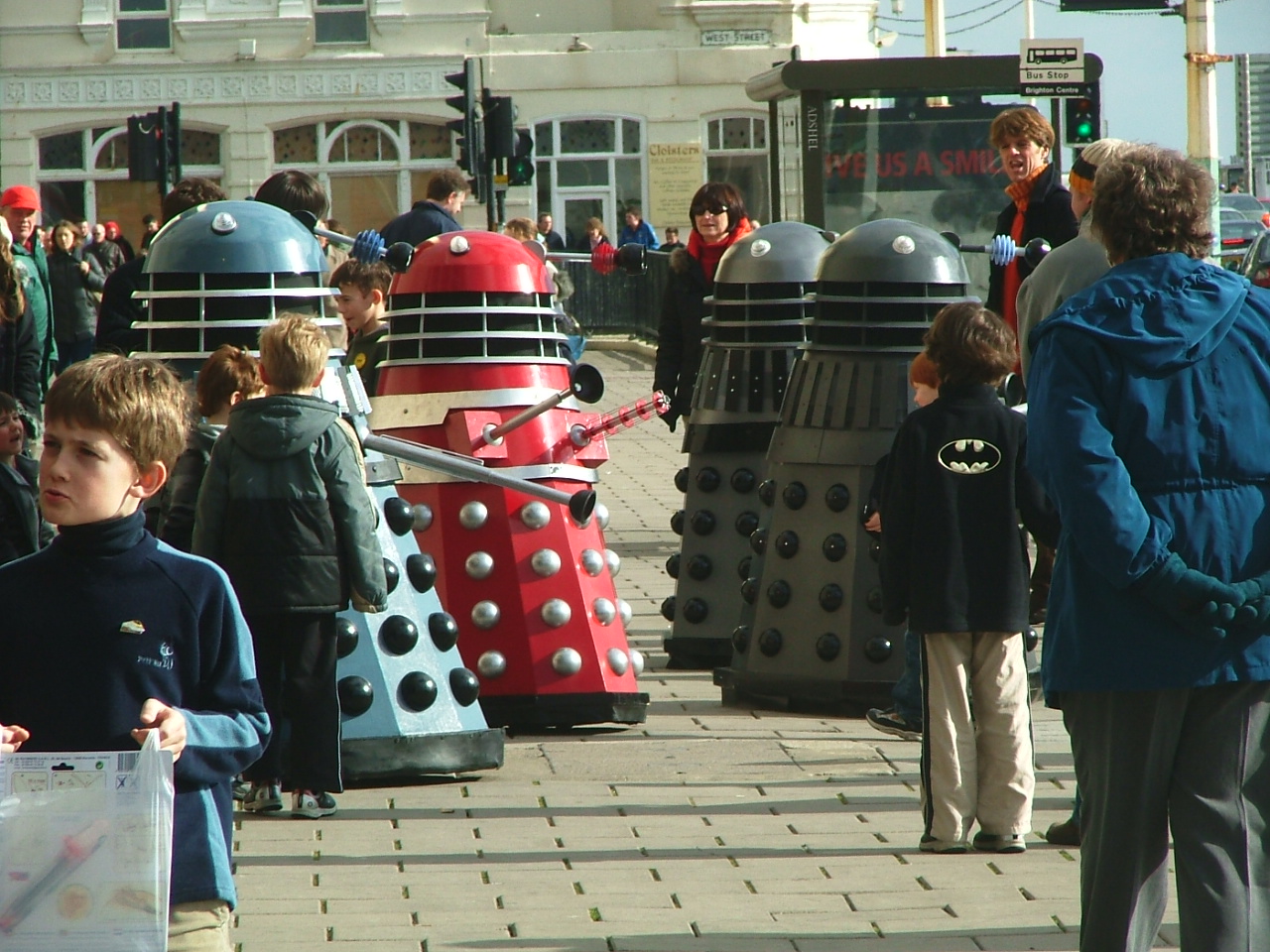 children gather around a sculpture of droid and dalec