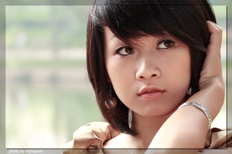 asian woman wearing celet looking ahead at camera