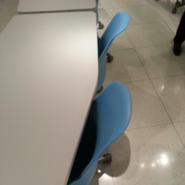 chairs that are next to a table in a room