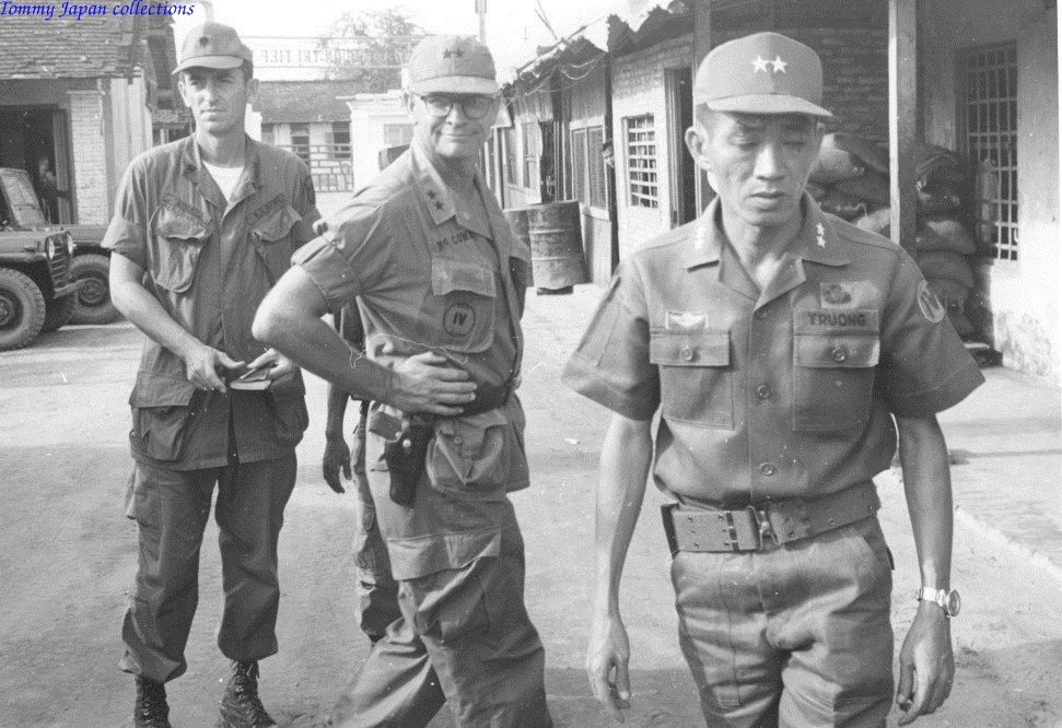 black and white po of a soldier with other soldiers on street