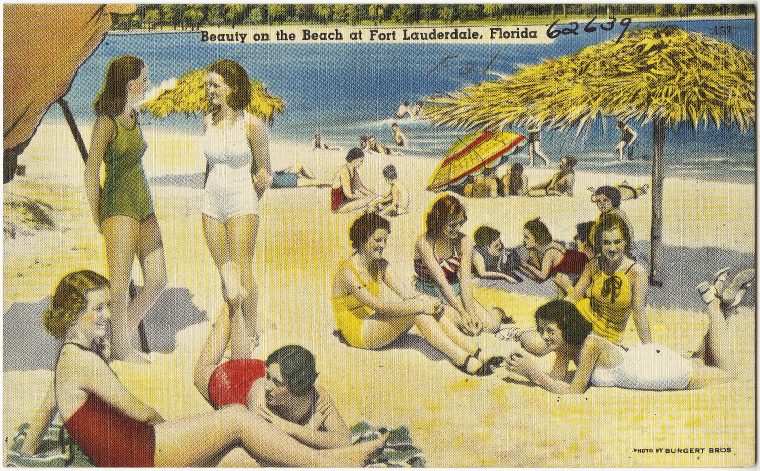 a man and woman on beach talking to others