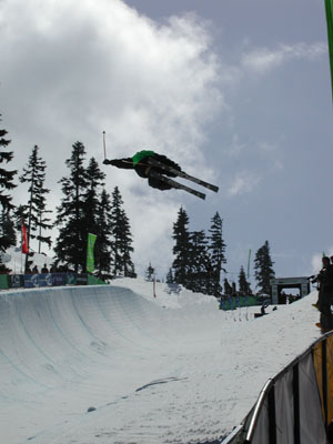 a person jumps in the air on skis