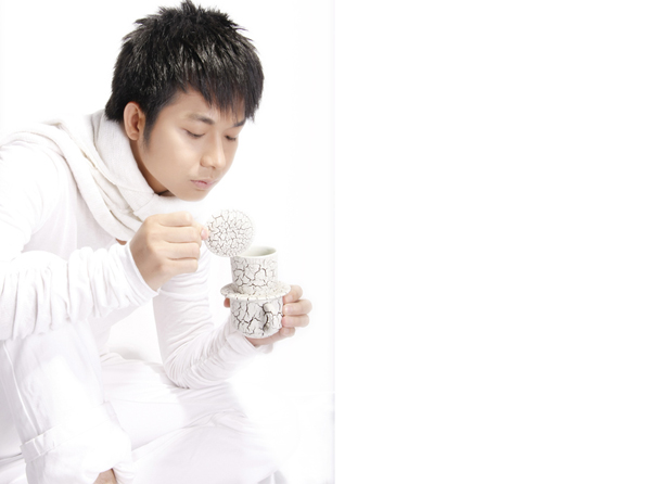 an asian man holding a jar with soing inside it