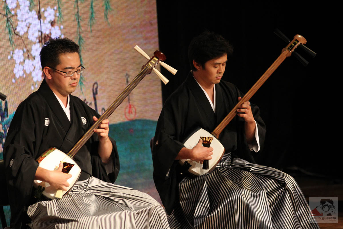 two japanese men perform a trick on the stage