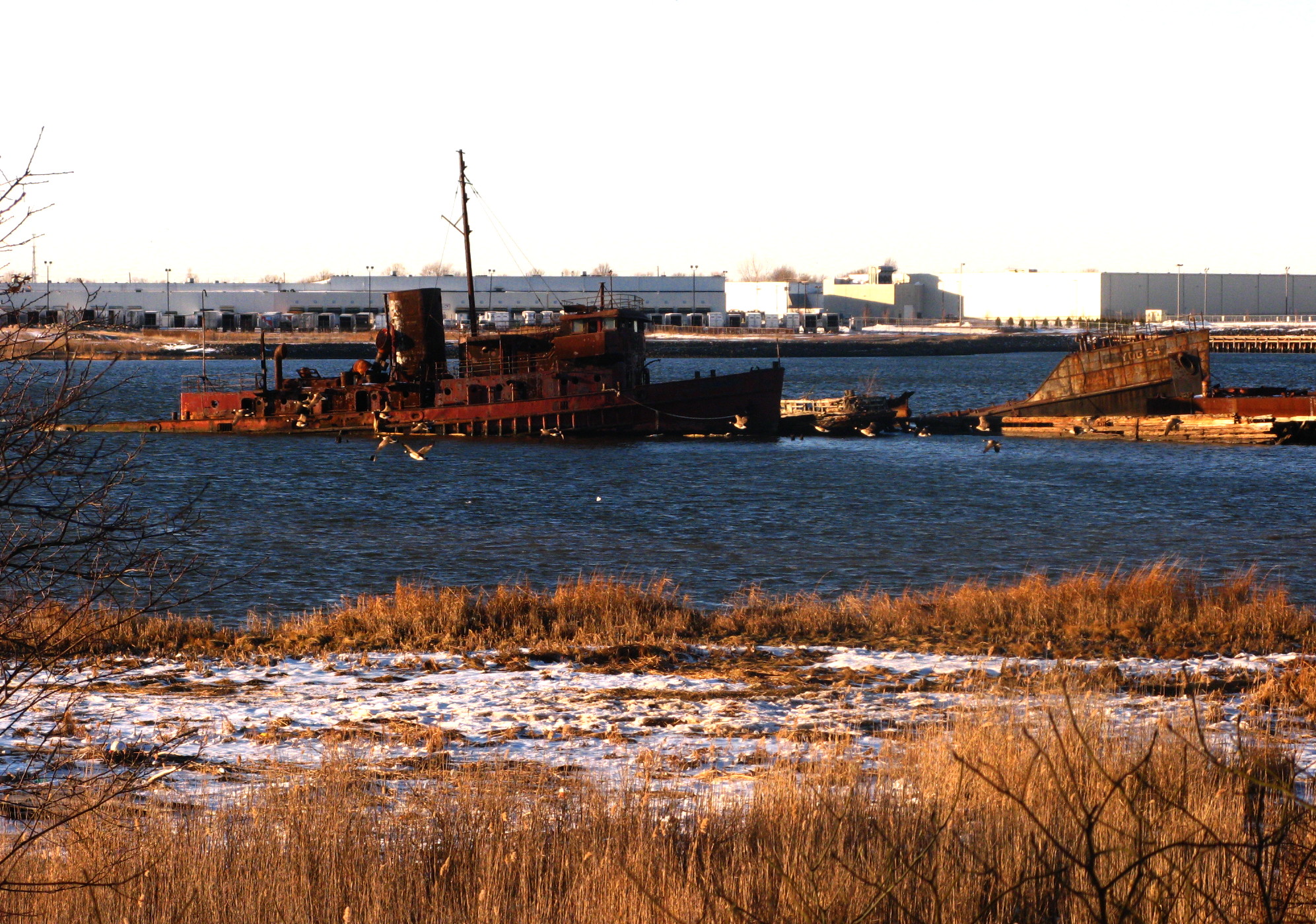 a rusted industrial ship in the middle of water