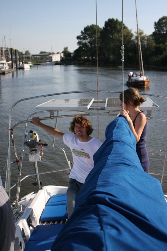 a man and woman sitting on top of a boat