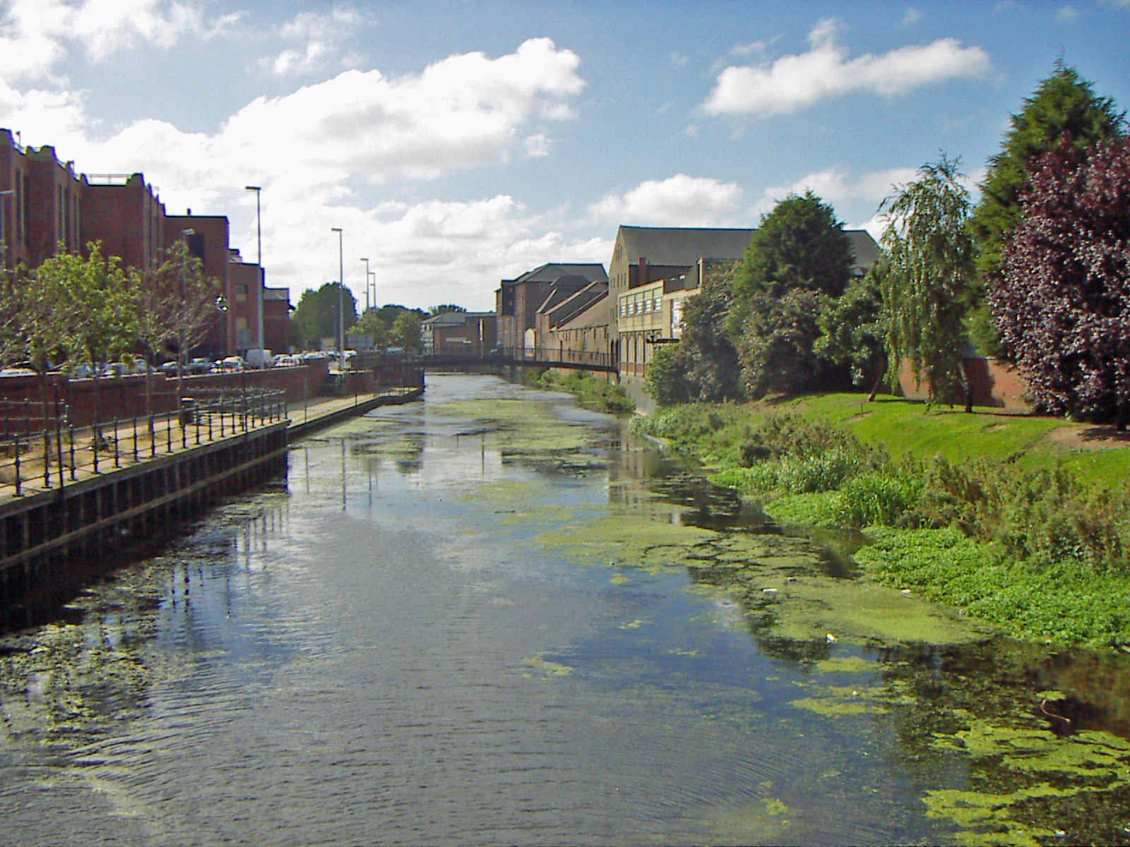 a narrow canal near some buildings and water