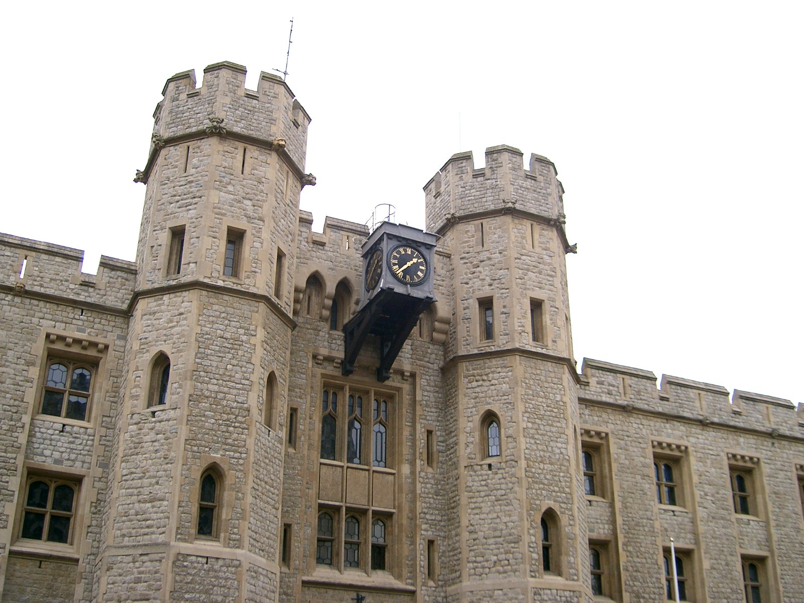 a large clock mounted to the side of a castle
