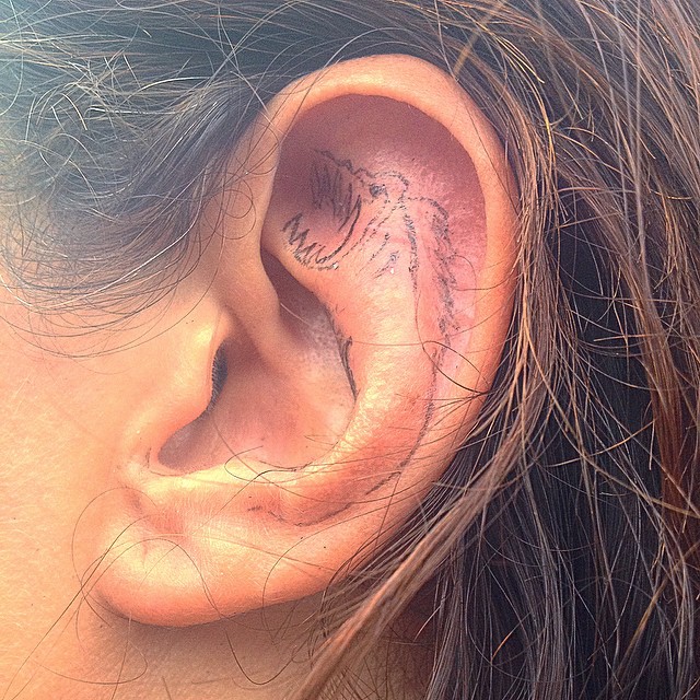 a woman's ear with an inscription in the middle