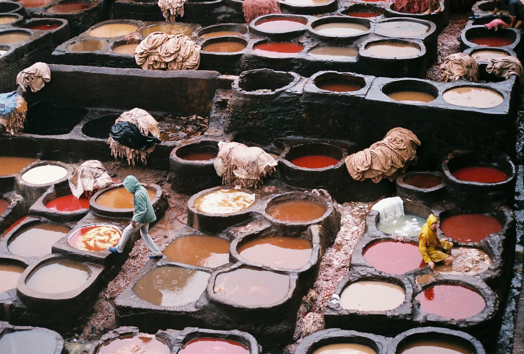 several pots of food with people in them