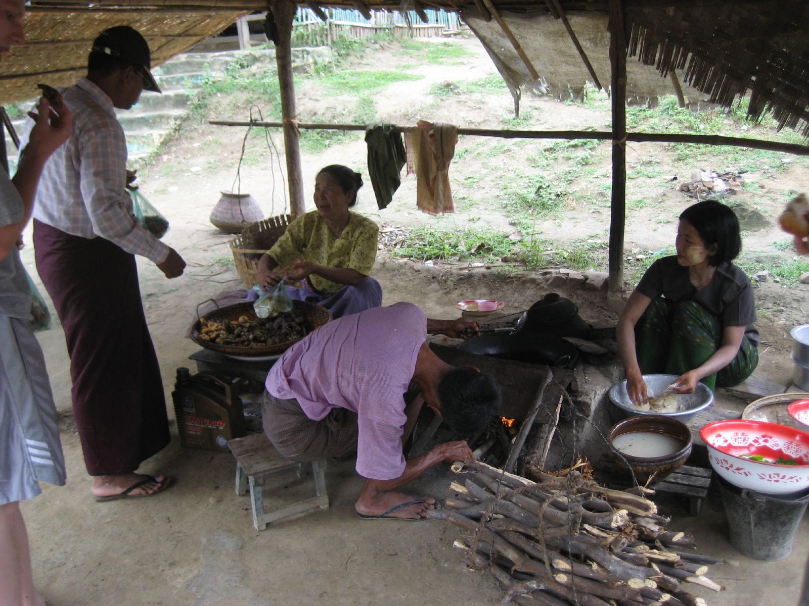 the people are preparing food on a wooden stove