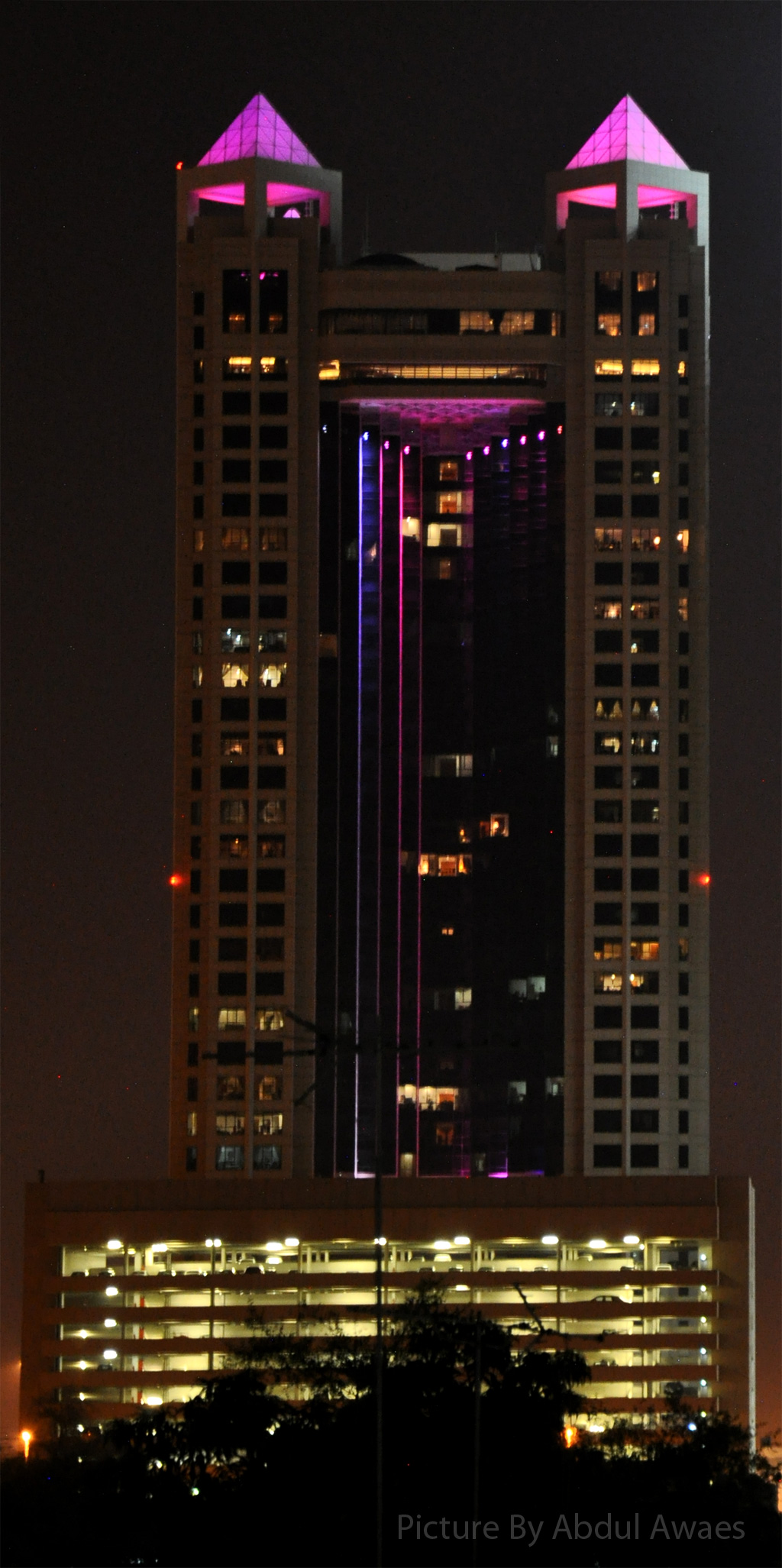 the tall building with lights is lit up at night