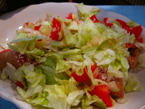 a big pile of salad with some meat in it