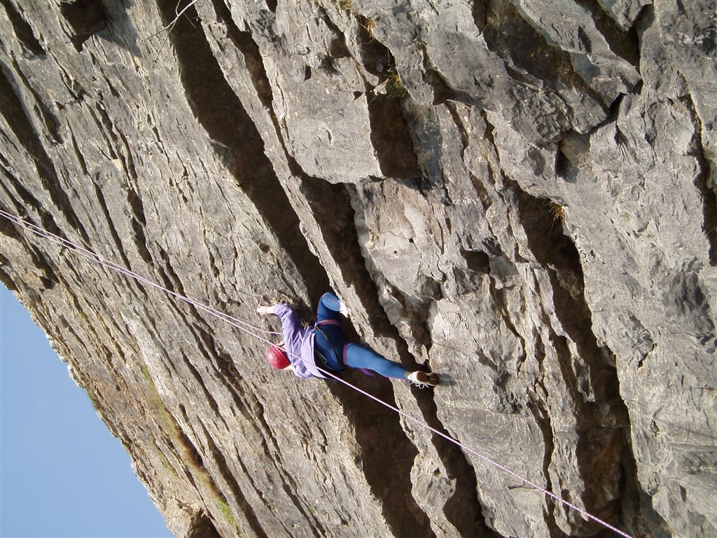 a man is climbing up a rock with rope