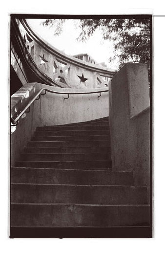 black and white pograph of steps leading up to stars on a roof