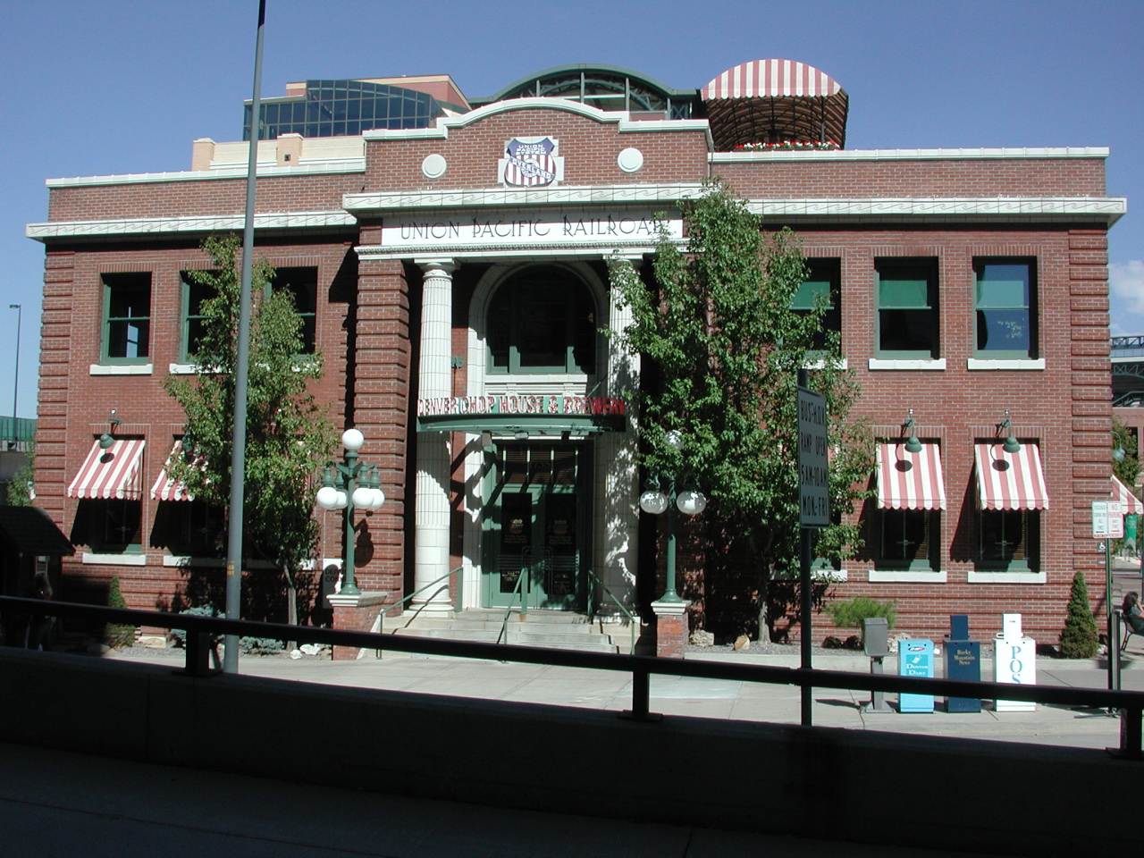 there is a tall red brick building that has flags on the front