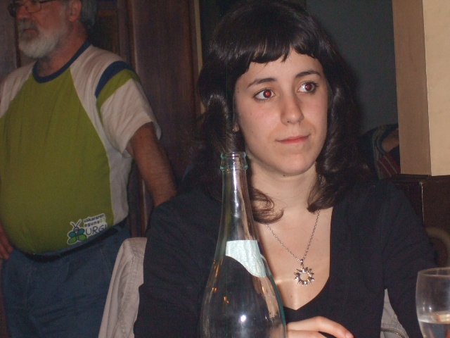 a woman with wine in a glass vase