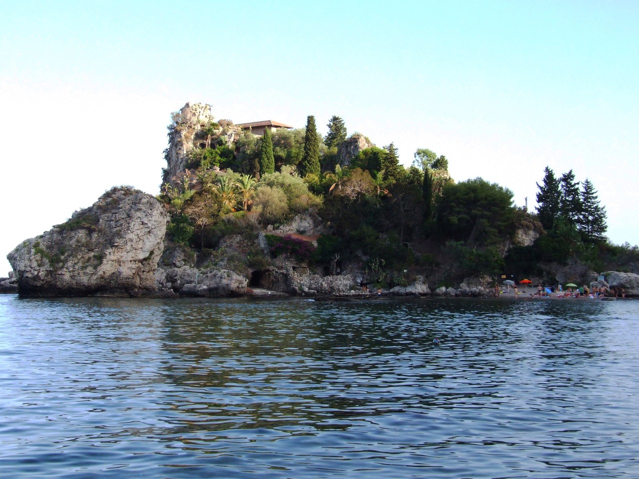 a small island on the water by the shore