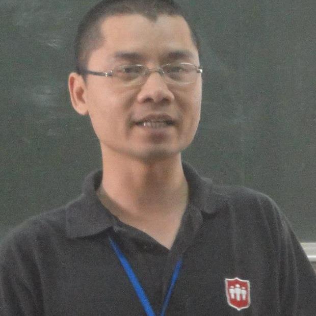 a man in glasses is standing in front of a chalkboard