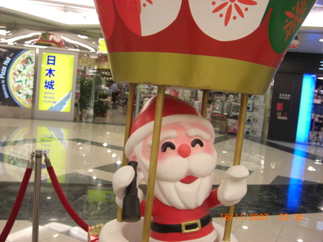 the santa claus is in the middle of the mall