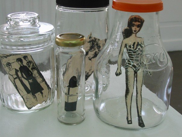 two jars with pictures of a woman and an orange lid