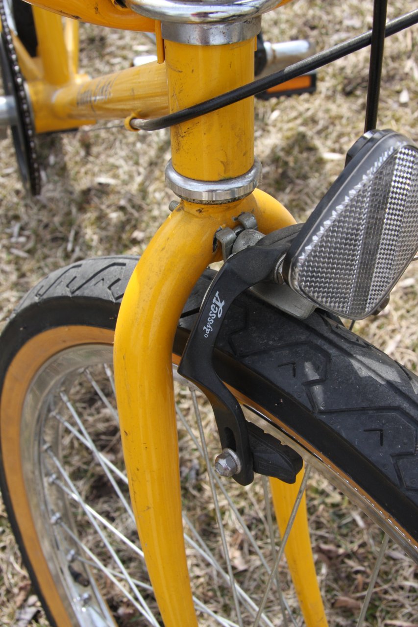 closeup of the back wheel on a yellow bike