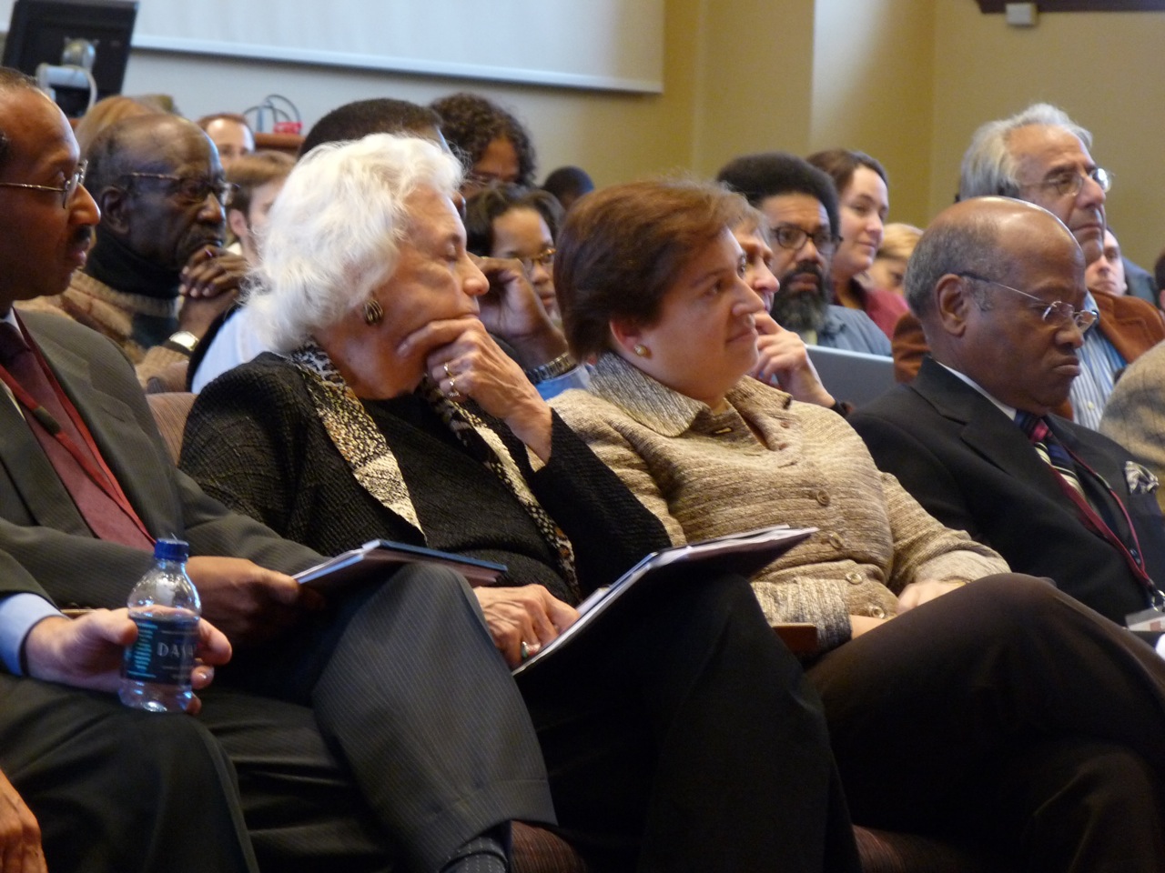 an audience of people with papers in their hands