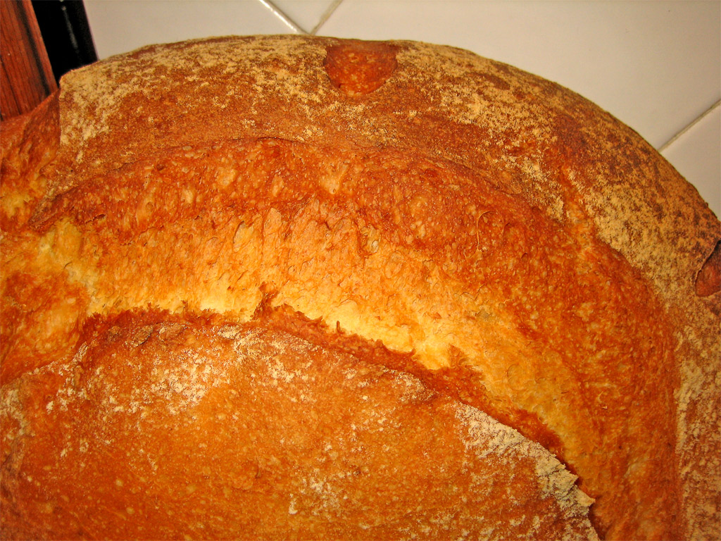 a big thick loaf of bread is lying on the counter