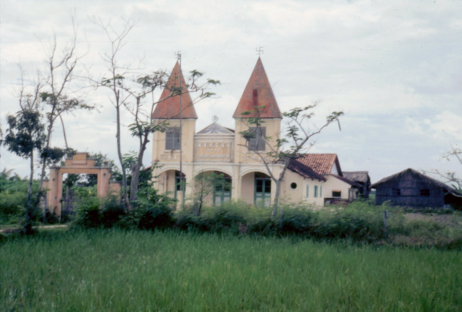 a tall church stands among the green foliage