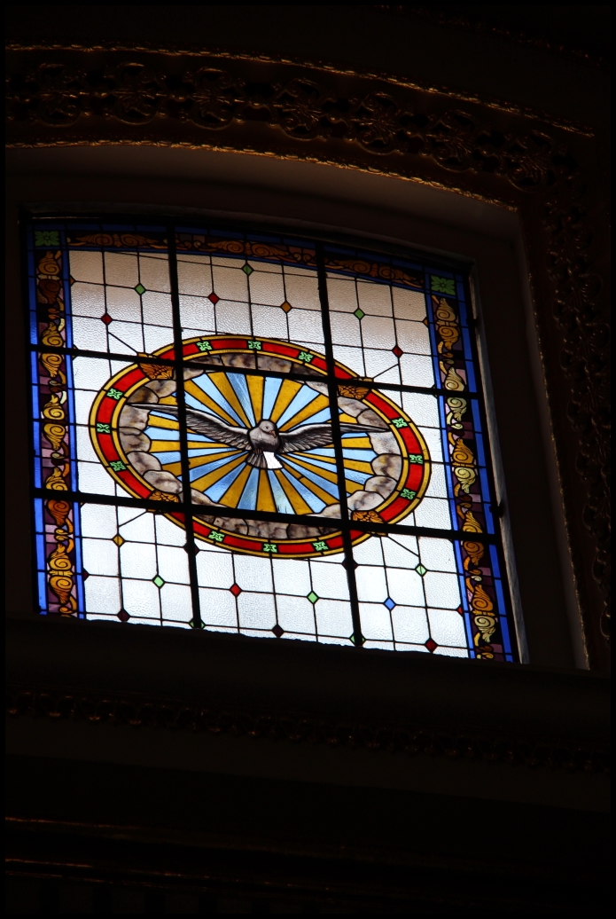 a colorful clock stained glass window inside a building