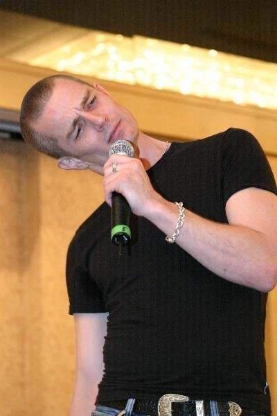a man in a black shirt holding a microphone