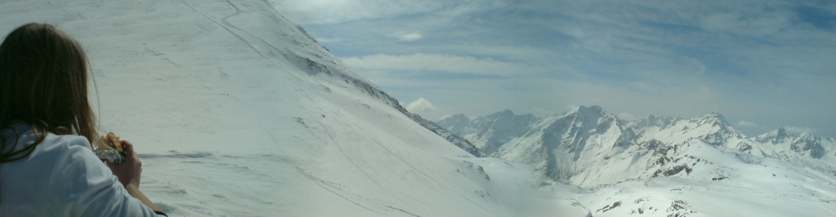 a woman standing on top of a snow covered slope