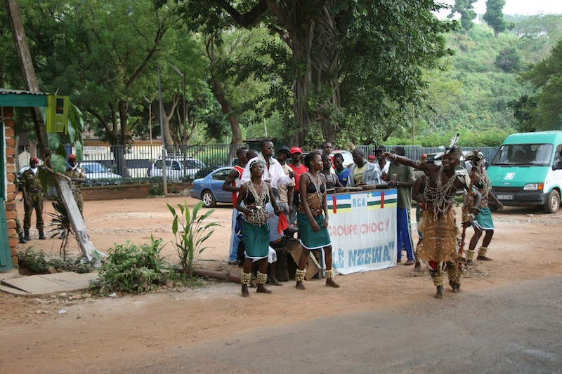 a group of men that are standing on the side of a road