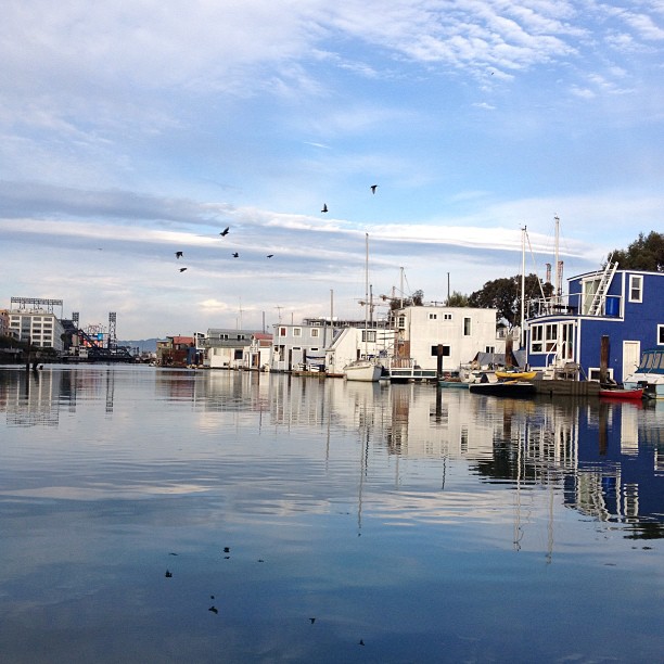 several boats are parked along the shore in a harbor