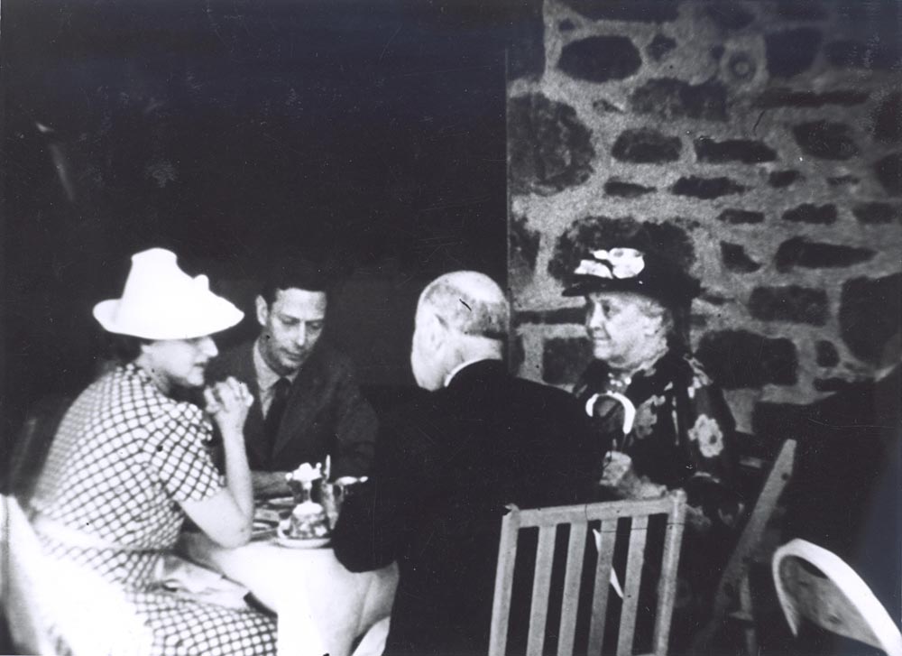 black and white pograph of people sitting at a table