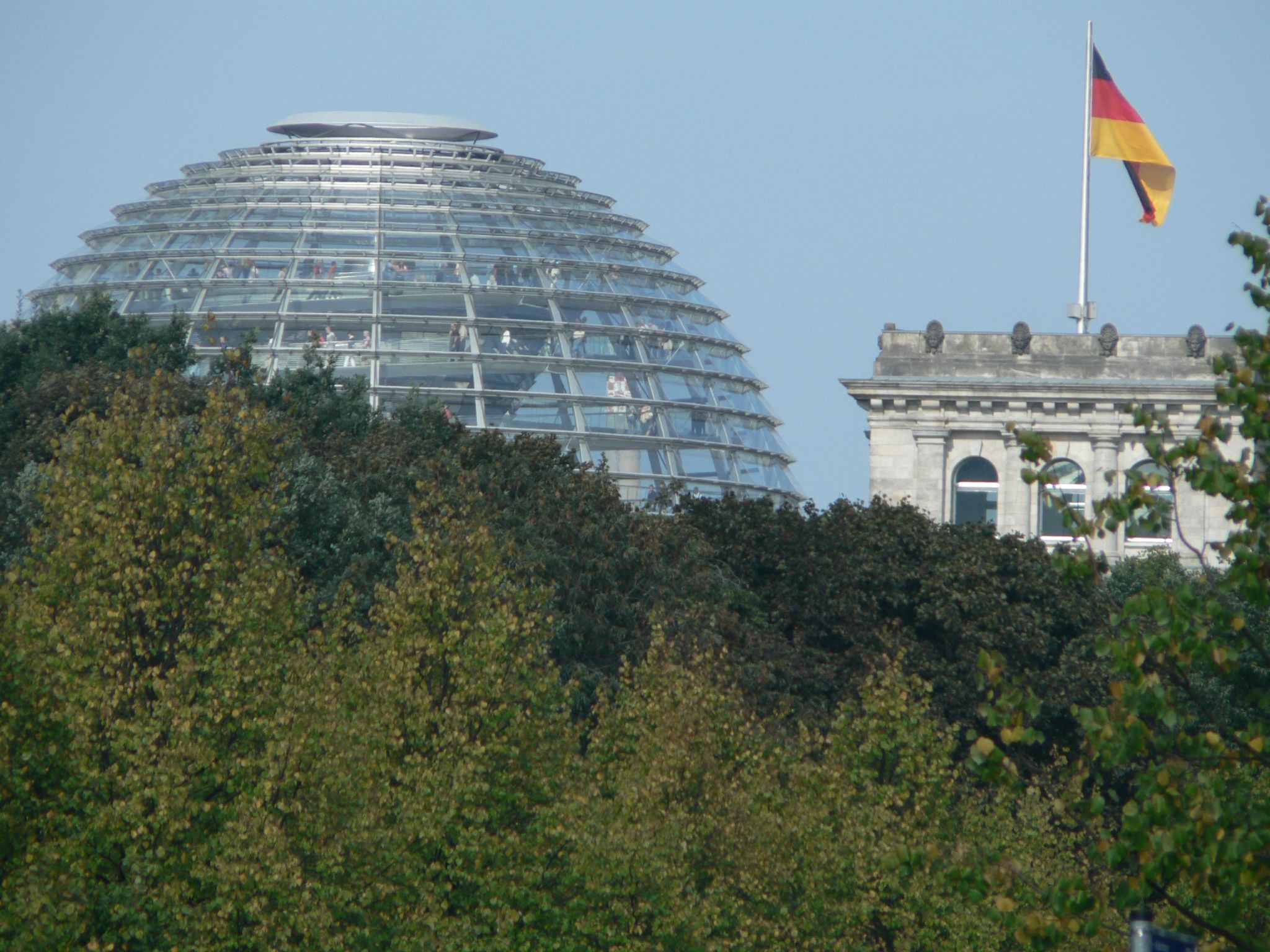 a view of some buildings that are near some trees