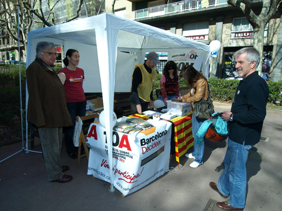 a man stands next to a booth selling items
