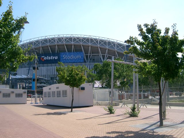 a baseball stadium with some trees around it