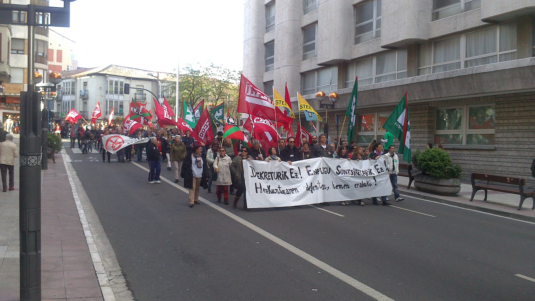 a large group of people holding a protest sign