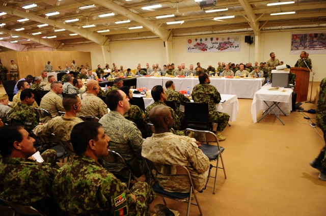 military men sitting at tables at a meeting